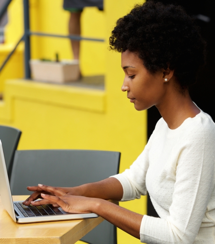 attractive-young-woman-using-laptop-outside-P9RLFGU.jpg